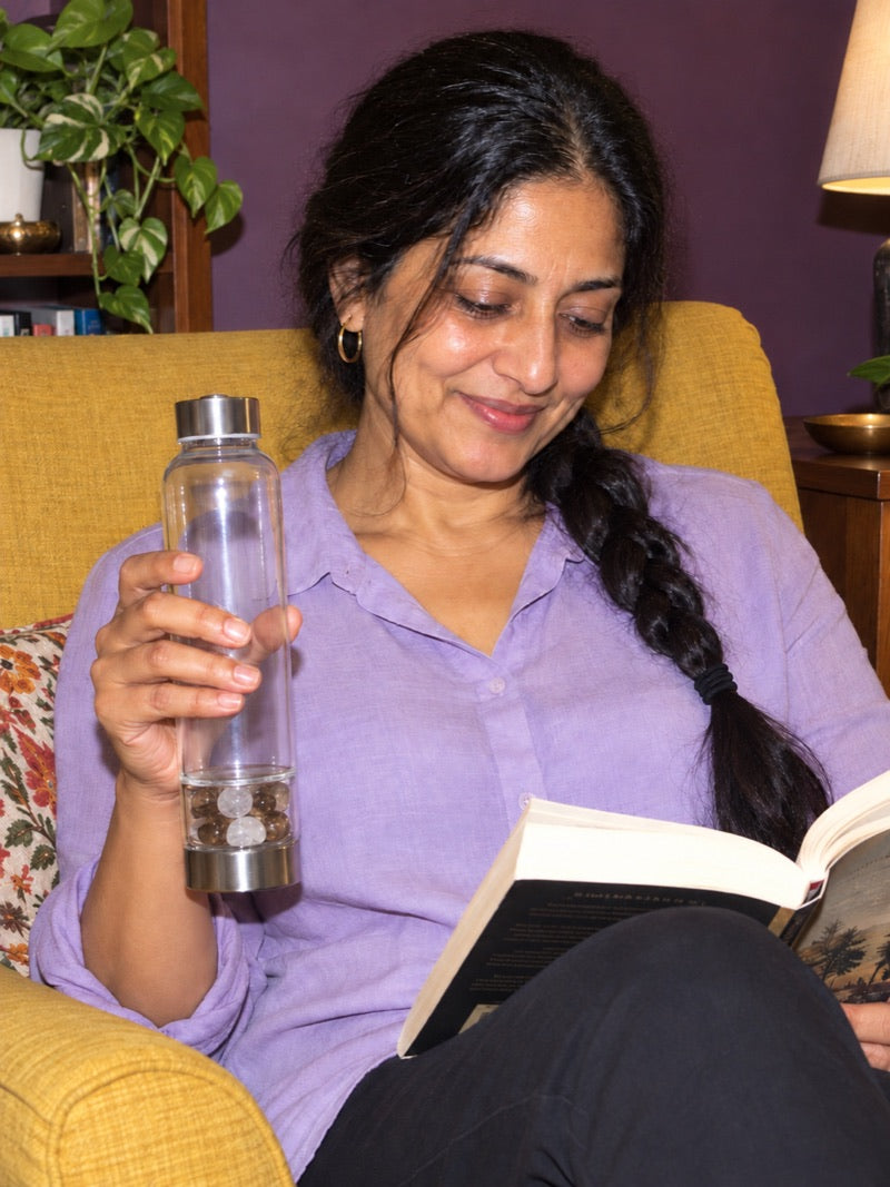 Reading in an armchair at home with an Elixir2Go in hand
