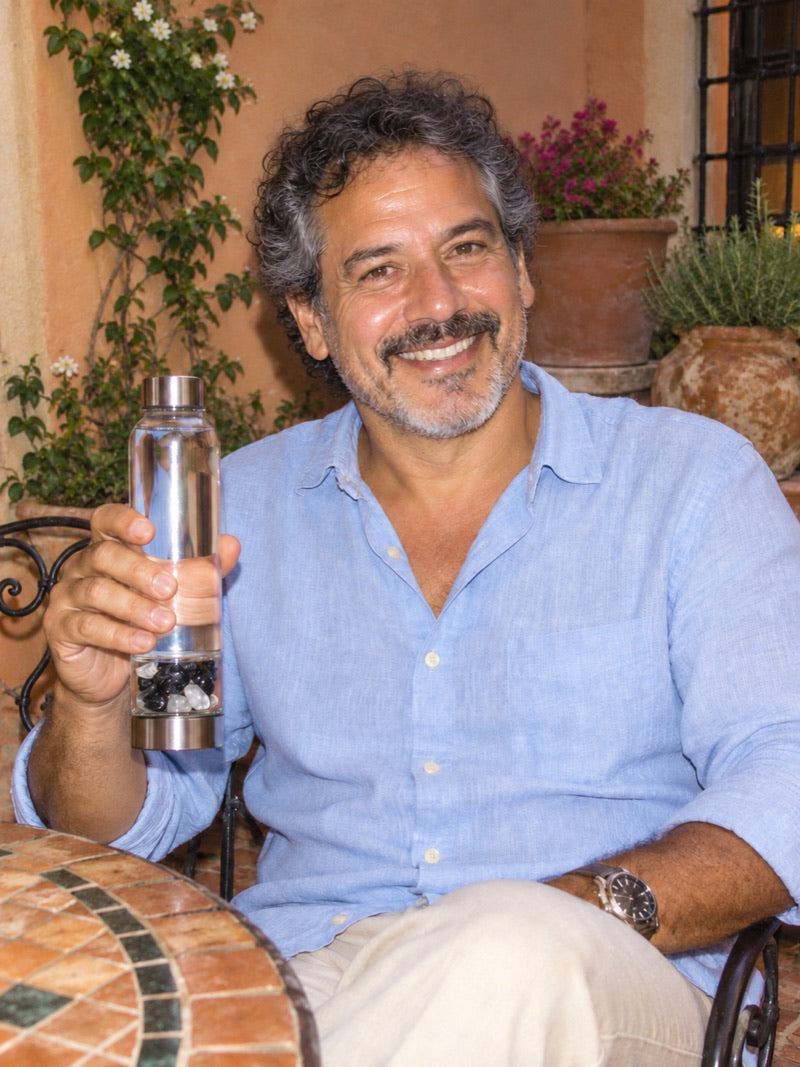 Relaxing at a terrace table, holding an Elixir2Go with Black Tourmaline and Clear Quartz
